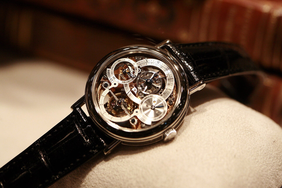 Breguet Classique Complications watch with a skeletonized dial on a black leather strap
