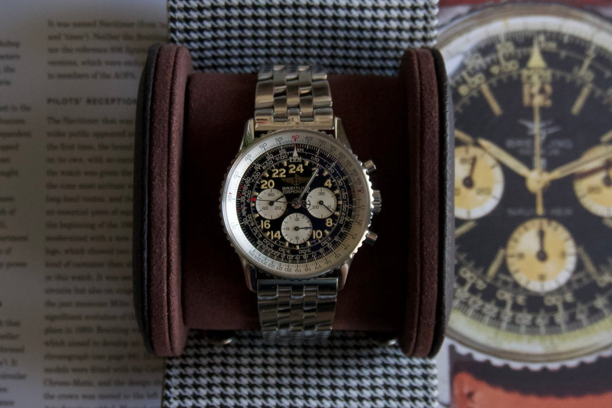 Breitling Navitimer Cosmonaute resting in The Espresso watch roll on an open book about the Navitimer