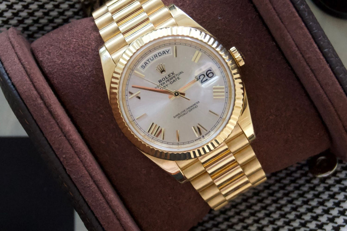 Yellow gold Rolex Day-Date resting in The Espresso watch roll